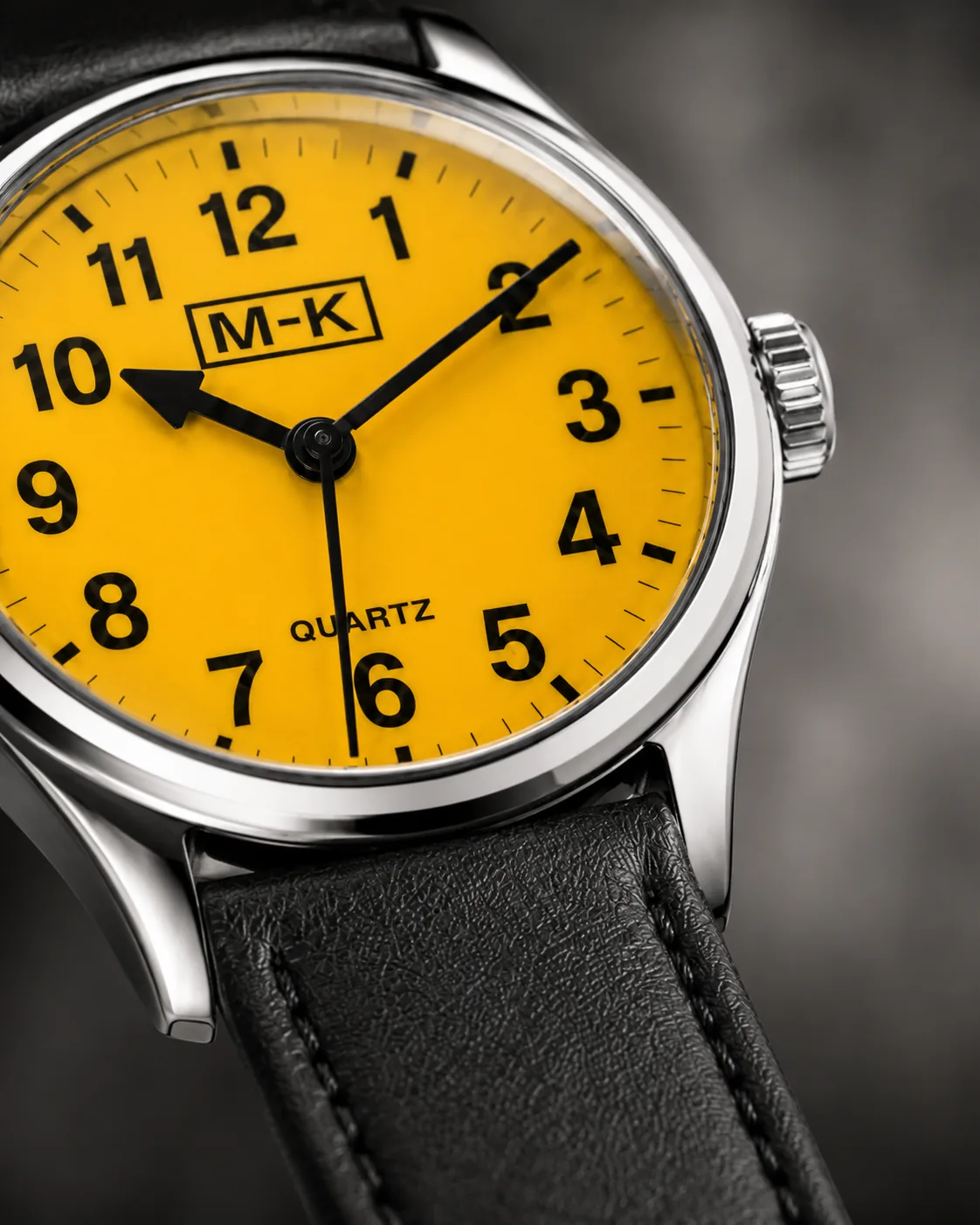 Macro view of the yellow dial, Arabic numerals, and black hands